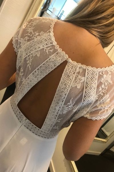 Hvid, kortærmet brudekjole med nærbillede af åben udskæring på ryg